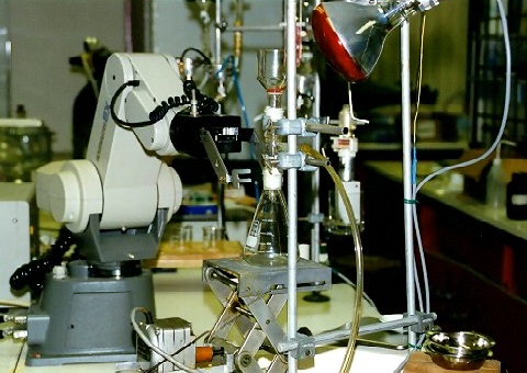 A picture of a robot performing an experiment in a laboratory.